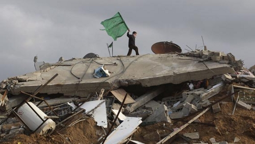 gaza-beit-lahia A Palestinian boy waves a Hamas flag over a house in Beit Lahia destroyed during Israel's 23-day onslaught against the Gaza Strip (Hatem Moussa / AP)